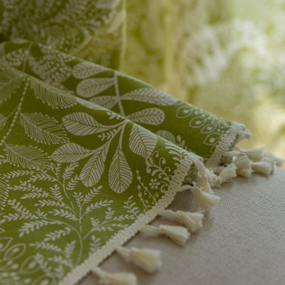 Green curtain with white leafy botanical pattern and cream tassels, hanging in a window with natural light. - Image 14