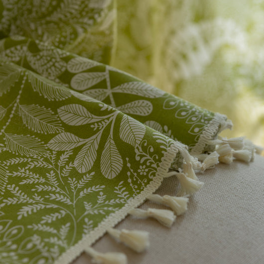 Green curtain with white leafy botanical pattern and cream tassels, hanging in a window with natural light. - Image 14