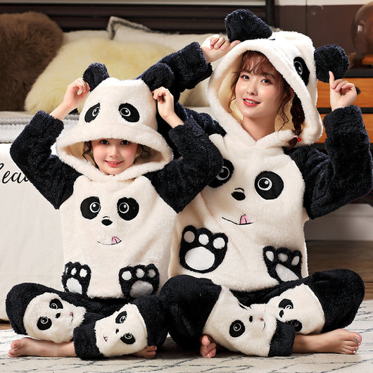Family wearing matching black and white panda plush housewear suits with hoods and checkered pants, posing indoors. - Image 16