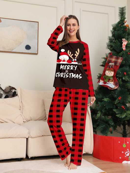 Family of four wearing matching red and black buffalo plaid Christmas pajamas with reindeer graphic. - Image 7