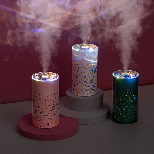 Dark green cylindrical humidifier with a clear top, featuring a colorful celestial pattern of stars, planets, and constellations. - Image 9