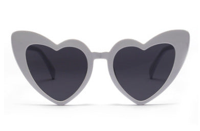 Heart-shaped tortoiseshell sunglasses with light brown lenses on a white background, perfect for women. - Image 4