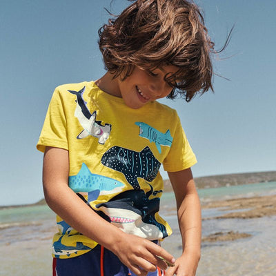 Dark blue short-sleeved children's t-shirt with multiple glowing jellyfish graphics and a yellow neck trim. - Image 2