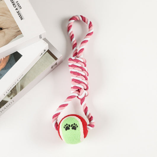 Red, pink, and white braided cotton rope dog toy with a green and red tennis ball featuring black paw prints. - Image 14