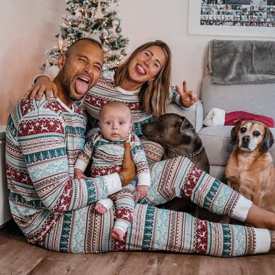 Family of four wearing matching Christmas pajamas with red, green, and grey Fair Isle reindeer and snowflake pattern. - Image 11