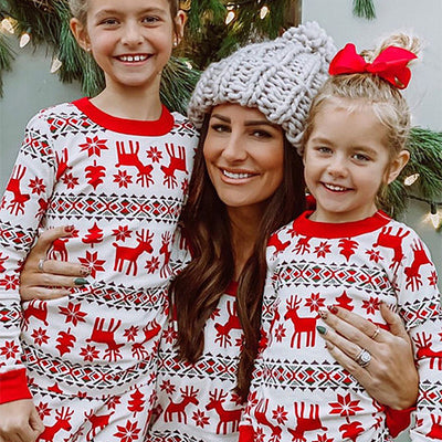 Mother and two daughters in matching red and white reindeer and snowflake print long-sleeve Christmas pajamas. - Image 17