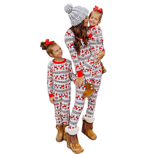 Mother and two daughters in matching red and white reindeer and snowflake print long-sleeve Christmas pajamas. - Image 25