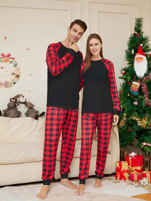 Woman wearing a black long-sleeve pajama top with red and black plaid raglan sleeves and matching plaid pants. - Image 13