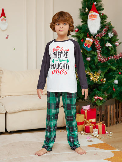 Man wearing a white and black raglan long-sleeve pajama top with a 'Dear Santa They're the Naughty Ones' graphic and green plaid pajama pants. - Image 12