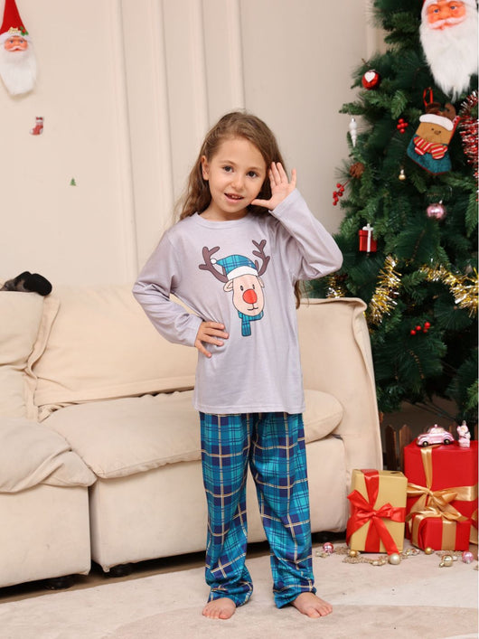 Young girl wearing a grey long-sleeve pajama top with a cartoon reindeer and blue plaid pajama pants. - Image 10