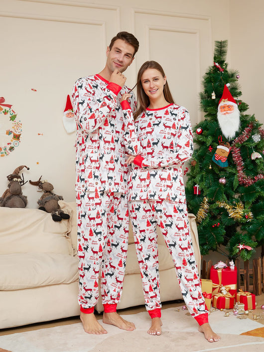 Young girl in white Christmas pajamas with red deer and tree print, red trim, standing by a decorated tree. - Image 13