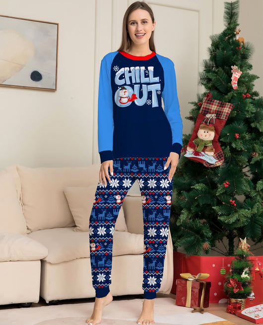 Woman wearing a navy blue and light blue Christmas pajama set with a "CHILL OUT" snowman graphic and fair isle patterned pants. - Image 12