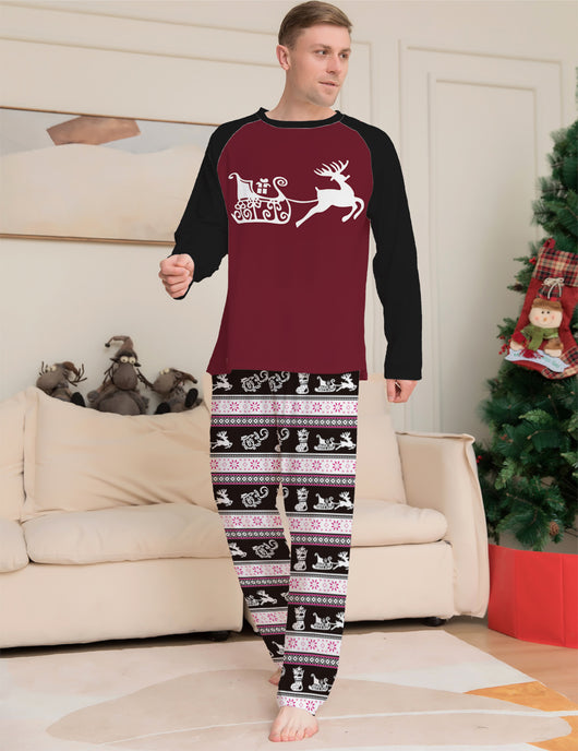 Child wearing a Christmas pajama set with a maroon and black reindeer top and black, pink, and white striped pants. - Image 8