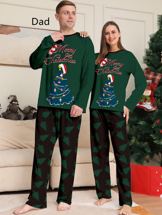 Young girl wearing a dark green long-sleeved Christmas pajama set with a decorated tree and "Merry Christmas" text. - Image 14