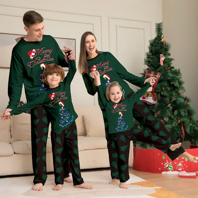 Young girl wearing a dark green long-sleeved Christmas pajama set with a decorated tree and "Merry Christmas" text. - Image 15