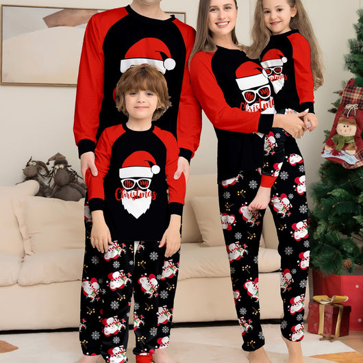 Woman wearing a black and red Christmas pajama set with a Santa Claus graphic top and snowman-patterned pants. - Image 11