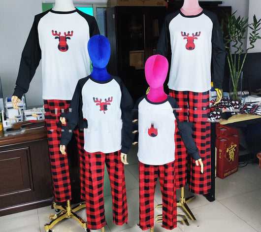 Matching family Christmas pajamas with white long-sleeve tops featuring a red plaid reindeer and red and black buffalo plaid pants. - Image 12
