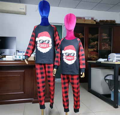 Family matching Christmas pajamas with a Santa Claus graphic wearing sunglasses and a '2021' mask, paired with red and black buffalo plaid pants. - Image 7