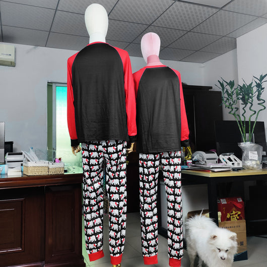 Family matching Christmas pajamas with black tops, red raglan sleeves, 'Joy Love Peace Believe Christmas' graphic, and polar bear print pants. - Image 10