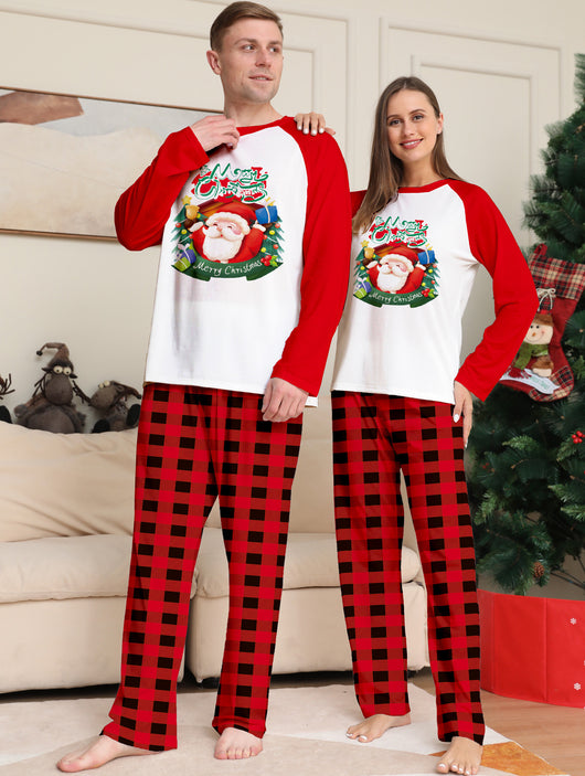 Man in a red and white Christmas pajama set with a Santa Claus graphic top and red and black plaid pants. - Image 13