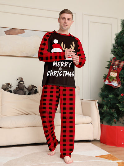 Family of four wearing matching red and black buffalo plaid Christmas pajamas with reindeer graphic. - Image 16