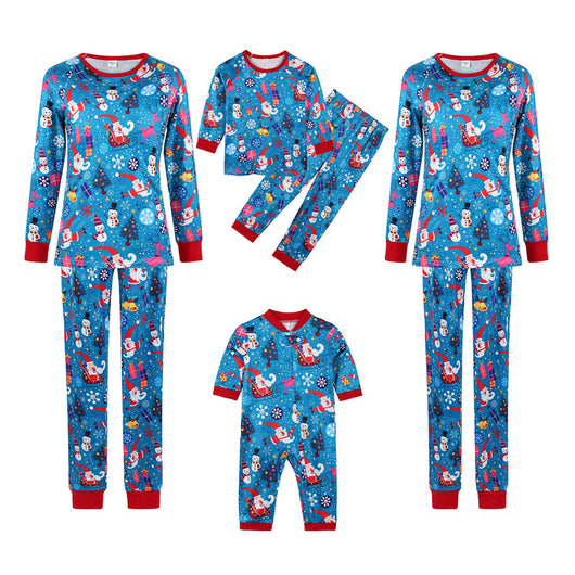Family matching Christmas pajamas in blue with Santa, snowman, and tree print. Includes adult two-piece sets and a baby romper. - Image 10