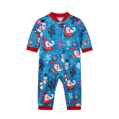 Family matching Christmas pajamas in blue with Santa, snowman, and tree print. Includes adult two-piece sets and a baby romper. - Image 13