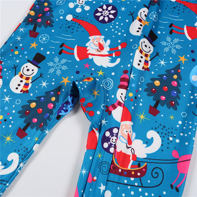 Family matching Christmas pajamas in blue with Santa, snowman, and tree print. Includes adult two-piece sets and a baby romper. - Image 15