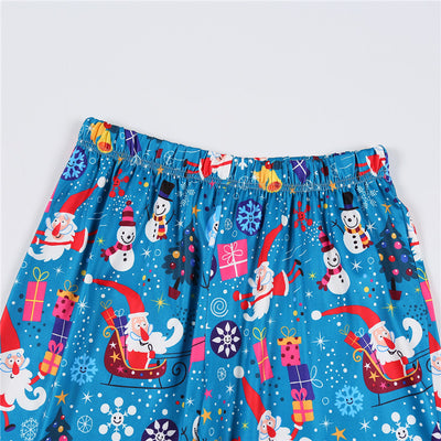 Family matching Christmas pajamas in blue with Santa, snowman, and tree print. Includes adult two-piece sets and a baby romper. - Image 17