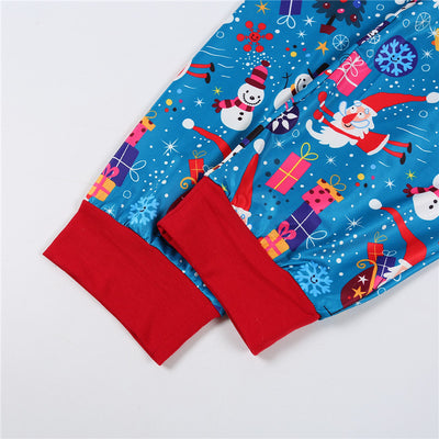 Family matching Christmas pajamas in blue with Santa, snowman, and tree print. Includes adult two-piece sets and a baby romper. - Image 18