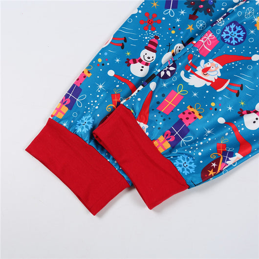 Family matching Christmas pajamas in blue with Santa, snowman, and tree print. Includes adult two-piece sets and a baby romper. - Image 18