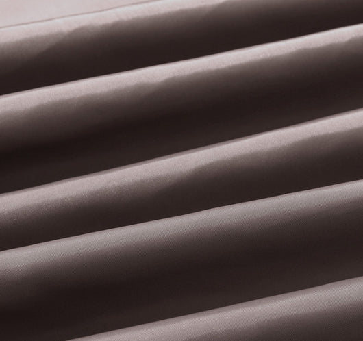 Solid brown polyester shower curtain with metal grommets and hooks, hanging from a silver shower rod. - Image 11