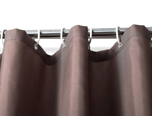 Solid brown polyester shower curtain with metal grommets and hooks, hanging from a silver shower rod. - Image 13