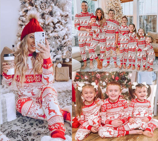 Family of eight wearing matching red and white Christmas pajamas with reindeer and snowflake patterns in a living room. - Image 8
