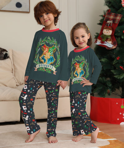 Family of four wearing matching dark green Hogwarts pajamas with a festive Harry Potter pattern, posing by a Christmas tree. - Image 7