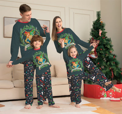 Family of four wearing matching dark green Hogwarts pajamas with a festive Harry Potter pattern, posing by a Christmas tree. - Image 9
