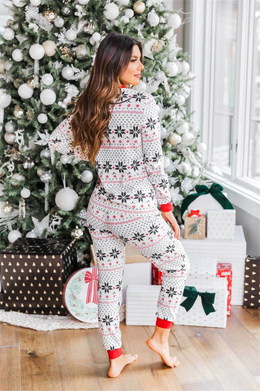Family of six wearing matching black, white, and red fair isle print Christmas pajamas with red cuffs and collars. - Image 23
