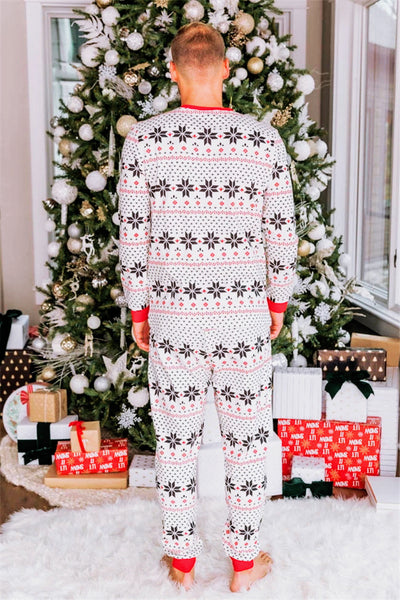 Family of six wearing matching black, white, and red fair isle print Christmas pajamas with red cuffs and collars. - Image 41