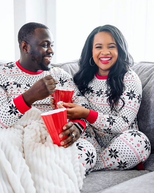 Family of six wearing matching black, white, and red fair isle print Christmas pajamas with red cuffs and collars. - Image 43