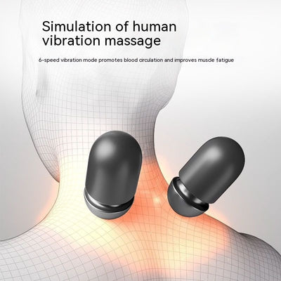 Dark gray cervical spine pillow with light gray textured massage area and power button on a light gray surface. - Image 16