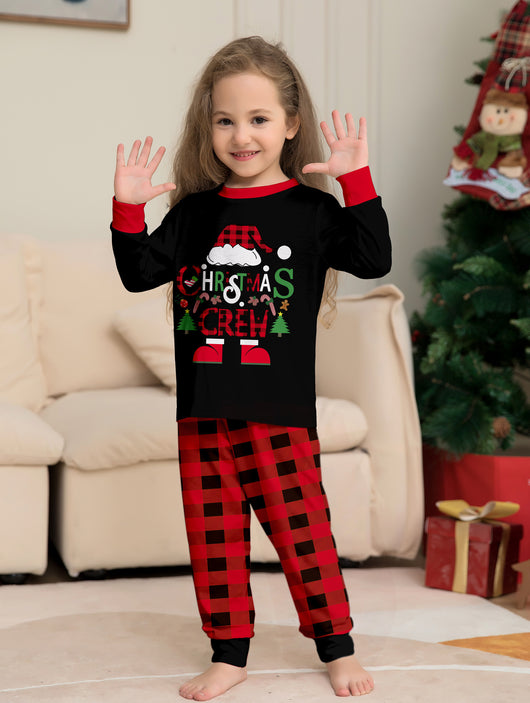 Man wearing black and red plaid Christmas pajamas with a Santa graphic top and matching pants. - Image 10