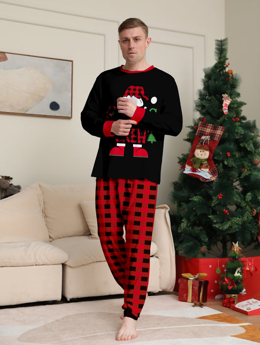 Man wearing black and red plaid Christmas pajamas with a Santa graphic top and matching pants. - Image 14