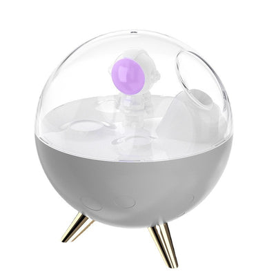 Space gray spaceman humidifier with a clear dome, glowing purple astronaut figurine, and warm yellow night light. - Image 11