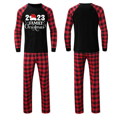 Red and black buffalo plaid Christmas pajama set with a long-sleeve top and matching pants. Top reads "2023 FAMILY Christmas". - Image 21
