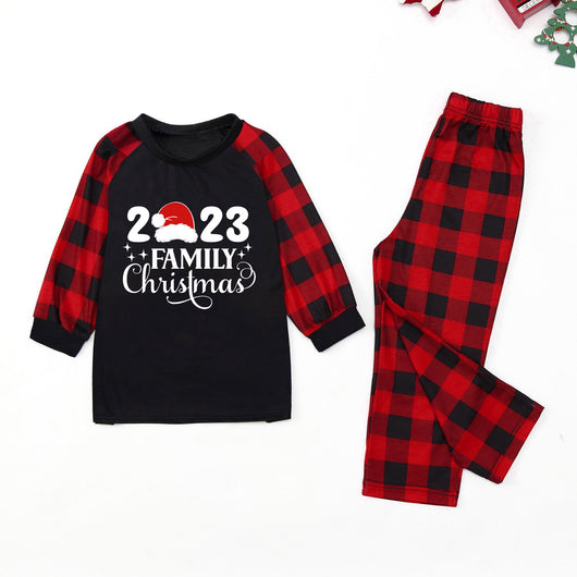 Red and black buffalo plaid Christmas pajama set with a long-sleeve top and matching pants. Top reads "2023 FAMILY Christmas". - Image 28