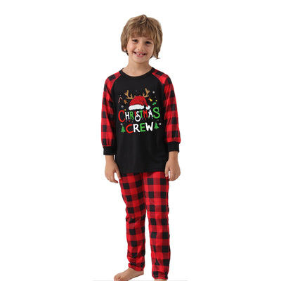 Man wearing a Christmas pajama set with a black long-sleeve top and red and black buffalo plaid pants. - Image 23
