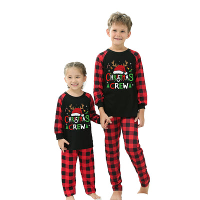 Man wearing a Christmas pajama set with a black long-sleeve top and red and black buffalo plaid pants. - Image 24