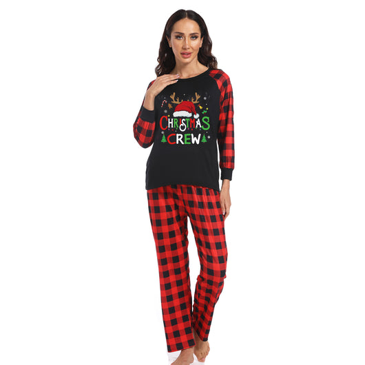 Man wearing a Christmas pajama set with a black long-sleeve top and red and black buffalo plaid pants. - Image 25