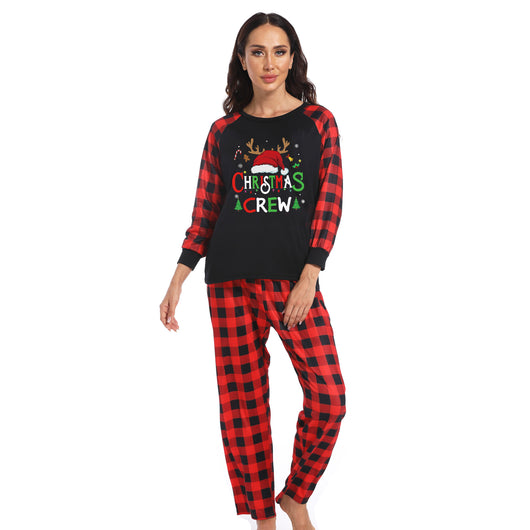 Man wearing a Christmas pajama set with a black long-sleeve top and red and black buffalo plaid pants. - Image 27