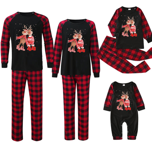 Matching family Christmas pajamas with black tops, red and black plaid sleeves, and glittery leopard print Christmas trees. - Image 11
